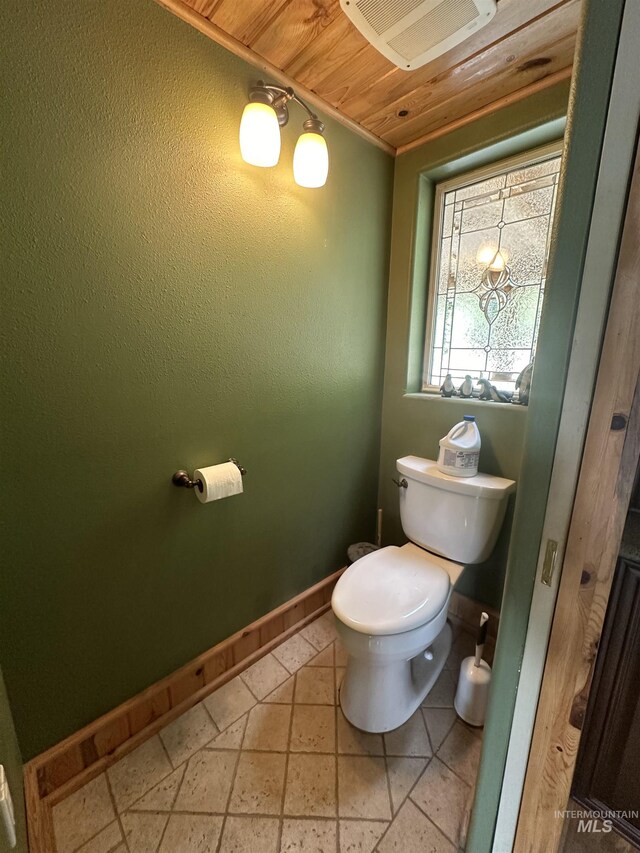 2223 Glenwood Rd, Kamiah, ID 83536 - bathroom featuring visible vents, baseboards, wooden ceiling, stone tile flooring, and toilet