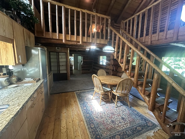 2223 Glenwood Rd, Kamiah, ID 83536 - dining space with wood-type flooring, log walls, and stairs