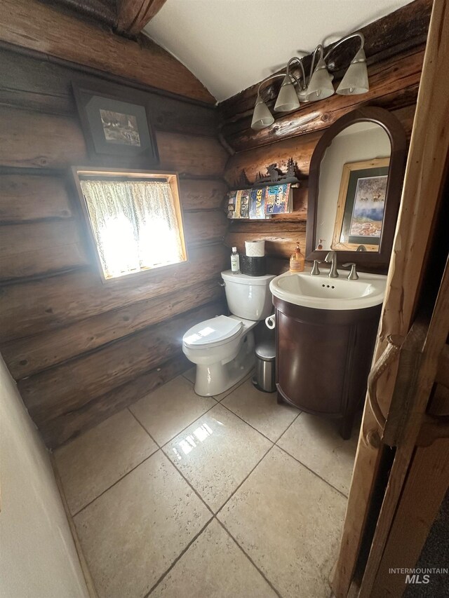 2223 Glenwood Rd, Kamiah, ID 83536 - bathroom featuring toilet, log walls, vanity, and lofted ceiling