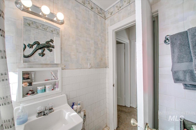 bathroom featuring tile walls and sink