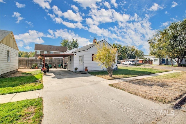 view of front facade with a carport and a front yard