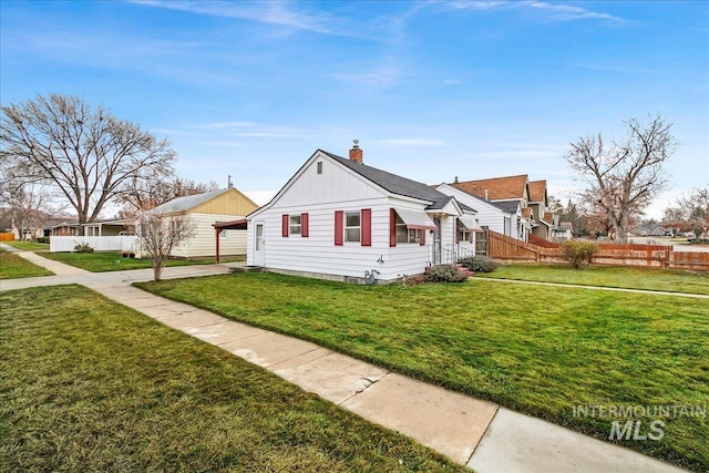 view of side of property featuring a yard and a carport