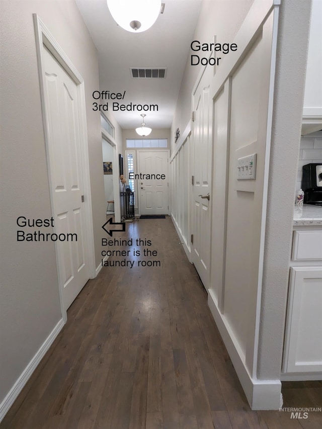 corridor with dark hardwood / wood-style flooring