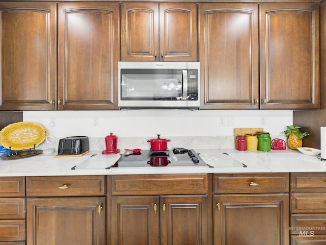 11 N 3rd W, St, Paul, ID 83347 - kitchen featuring stainless steel microwave, light countertops, and black electric stovetop