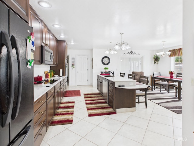 11 N 3rd W, St, Paul, ID 83347 - kitchen with black appliances, a chandelier, light countertops, pendant lighting, and a sink