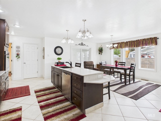 11 N 3rd W, St, Paul, ID 83347 - kitchen featuring a chandelier, stainless steel dishwasher, light tile patterned floors, a sink, and dark brown cabinets