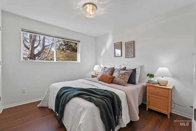 bedroom with dark wood-type flooring