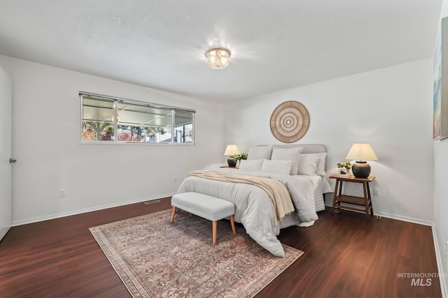 bedroom featuring dark wood-type flooring