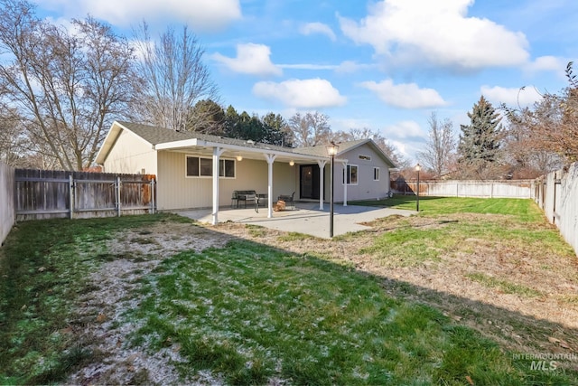 back of house featuring a yard and a patio