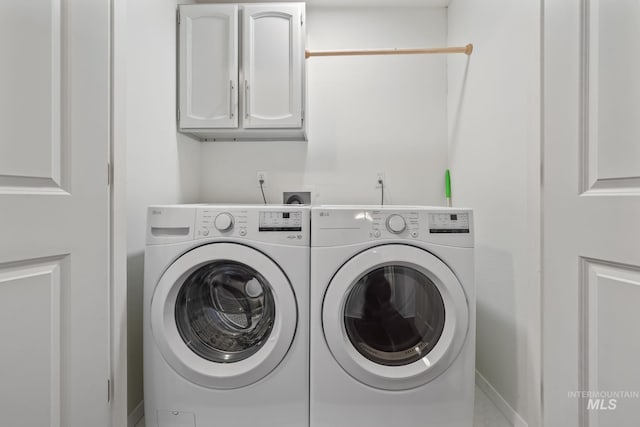 laundry area featuring cabinets and washing machine and dryer