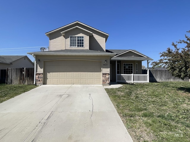 3915 N Abbott St, Caldwell, ID 83607 - traditional-style house with a porch, concrete driveway, stone siding, and a garage