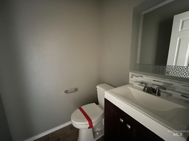 3915 N Abbott St, Caldwell, ID 83607 - half bath with backsplash, toilet, vanity, and baseboards