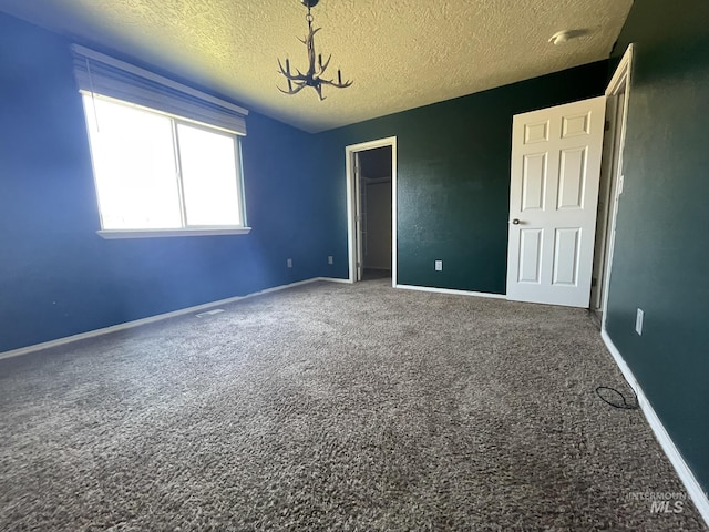 3915 N Abbott St, Caldwell, ID 83607 - unfurnished bedroom with carpet, a chandelier, a textured ceiling, a closet, and baseboards