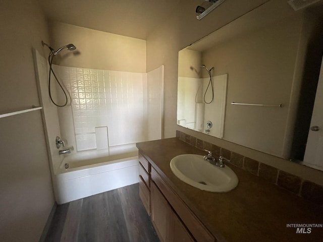 3915 N Abbott St, Caldwell, ID 83607 - bathroom with vanity, wood finished floors, and shower / washtub combination