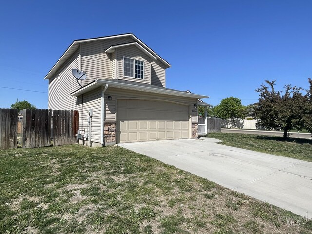 3915 N Abbott St, Caldwell, ID 83607 - view of home's exterior with driveway, a garage, and stone siding