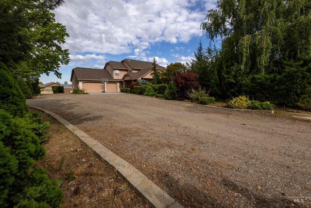 2105 N Washington Ave, Emmett, ID 83617 - view of property hidden behind natural elements featuring driveway and an attached garage