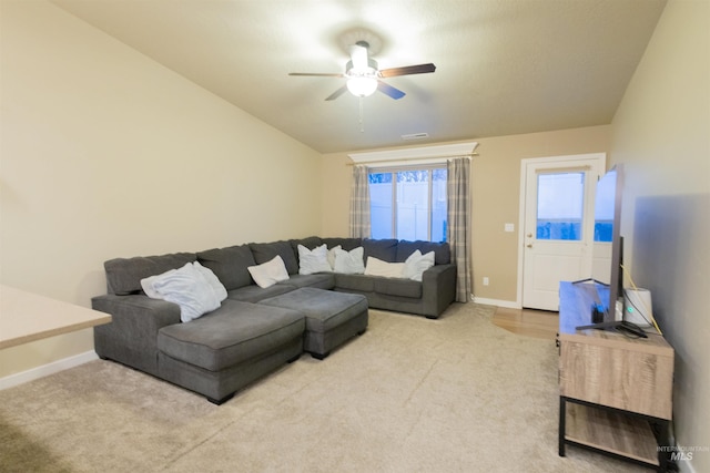 carpeted living room featuring ceiling fan and vaulted ceiling