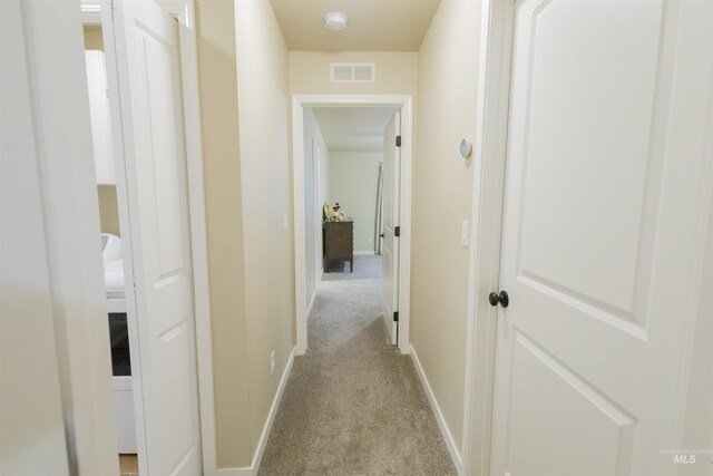 hallway with light carpet