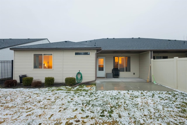 snow covered house with a patio area