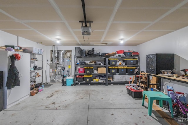 garage featuring electric water heater and a garage door opener