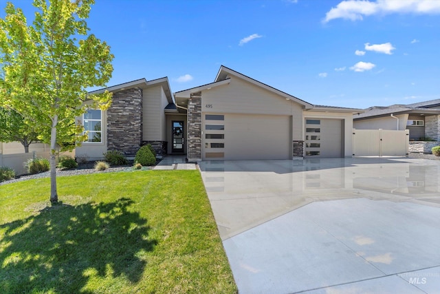 view of front of house featuring stone siding, an attached garage, and driveway