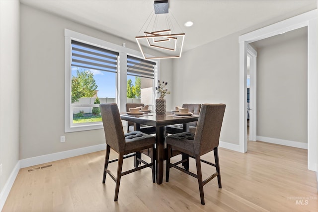dining area featuring light wood-style floors, baseboards, a chandelier, and recessed lighting