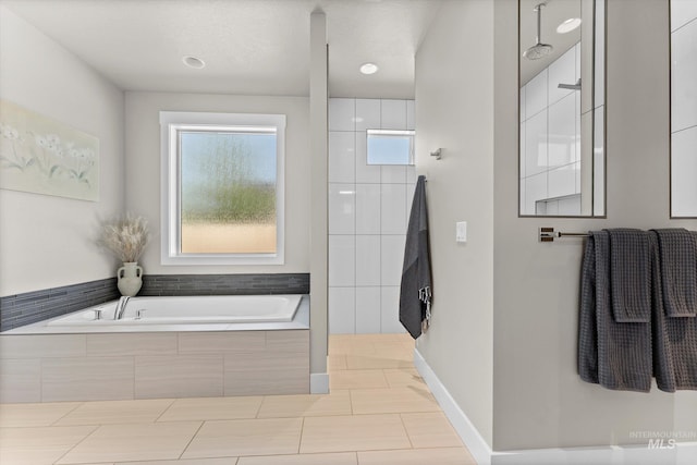 full bathroom featuring a garden tub, walk in shower, and tile patterned floors
