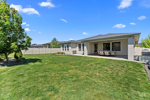 rear view of property with stucco siding and a patio