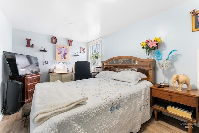 bedroom featuring wood finished floors