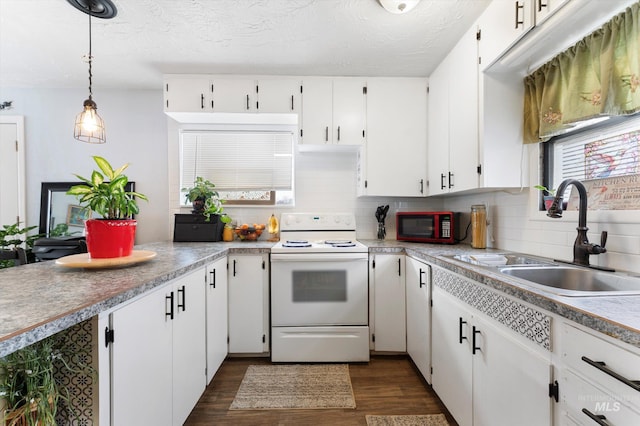 kitchen with white electric stove, a sink, white cabinetry, backsplash, and dark wood finished floors