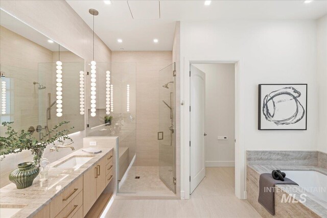 1112 W Main St Unit 503, Boise, ID 83702 - bathroom featuring a garden tub, a stall shower, double vanity, tile patterned flooring, and recessed lighting