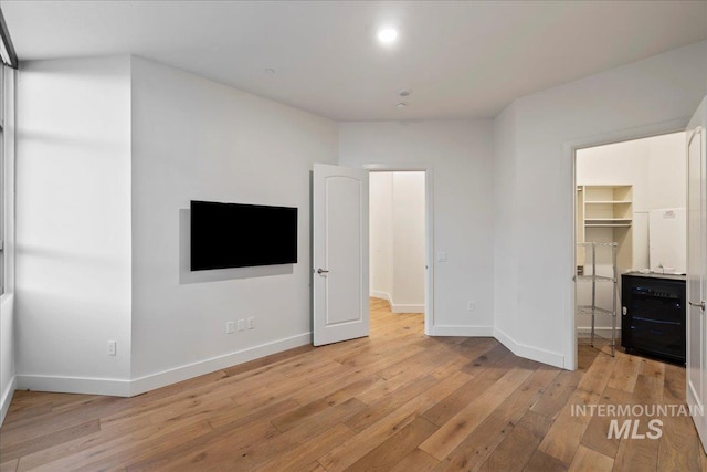 1112 W Main St Unit 503, Boise, ID 83702 - unfurnished bedroom with light wood-type flooring, a walk in closet, and a closet