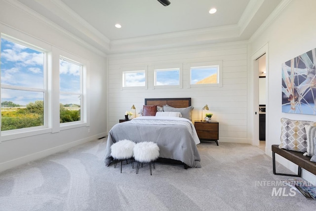bedroom featuring ornamental molding, light carpet, multiple windows, a raised ceiling, and recessed lighting
