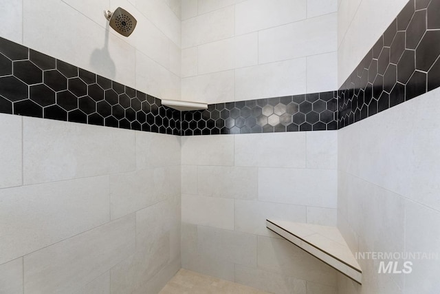 full bath featuring a tile shower