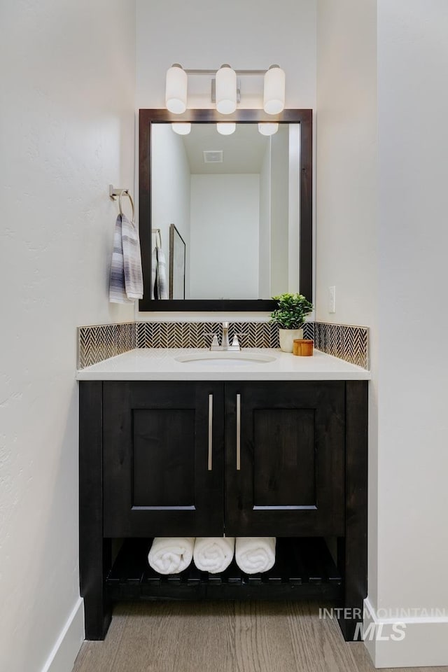 bathroom with vanity and baseboards