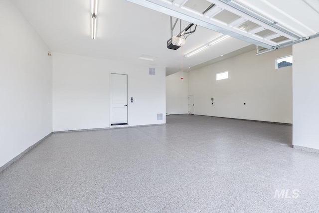 garage with a garage door opener and baseboards