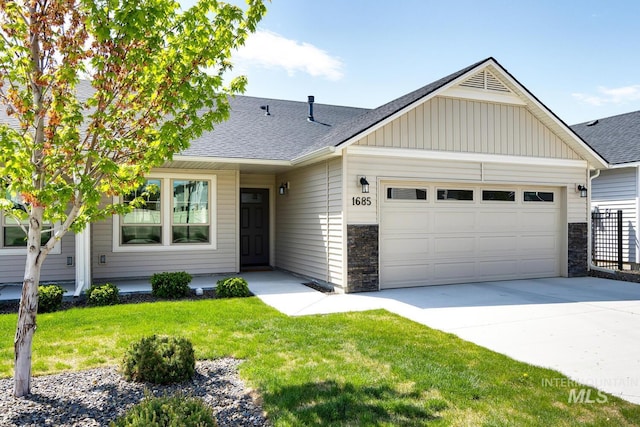 view of front of home with board and batten siding, driveway, a garage, a shingled roof, and stone siding