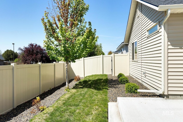 view of yard with a fenced backyard