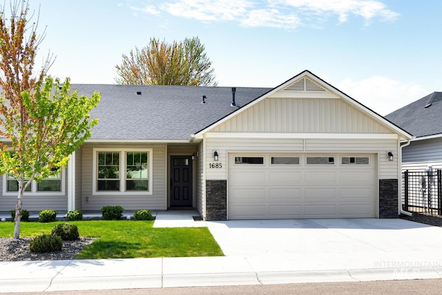 view of front of home featuring board and batten siding, driveway, an attached garage, a shingled roof, and stone siding