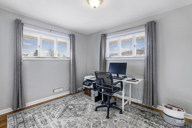 home office featuring baseboards and wood finished floors