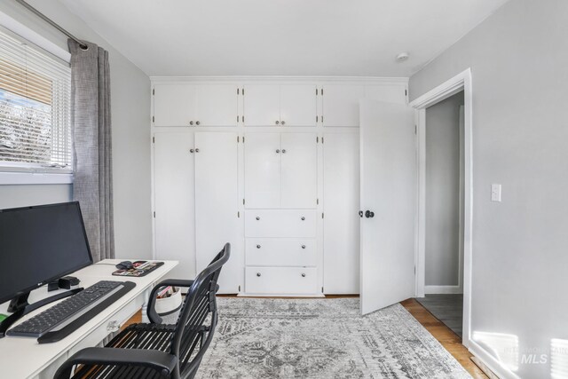 home office with light wood finished floors and baseboards