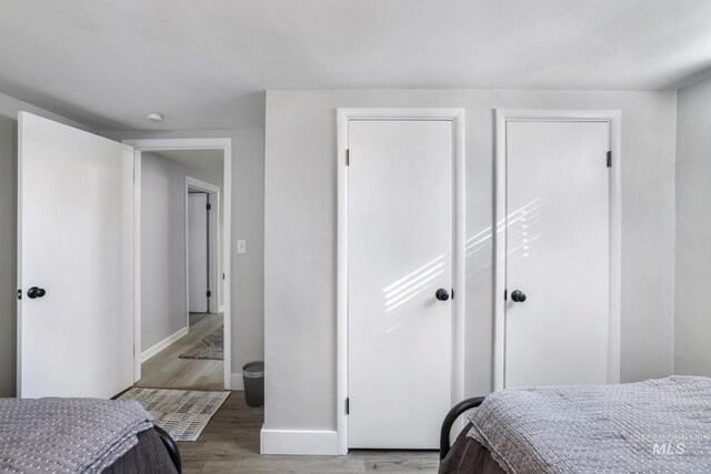 bedroom with wood finished floors and baseboards