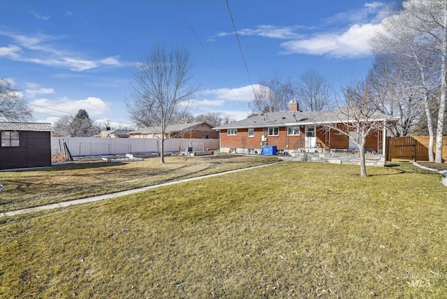 view of yard featuring an outbuilding, entry steps, and fence