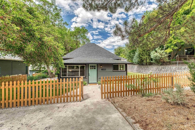1605 N 5th St, Boise, ID 83702 - view of front of home featuring roof with shingles, covered porch, a fenced front yard, and a gate