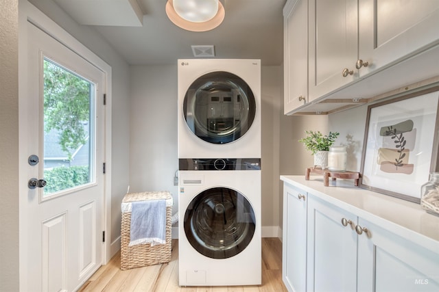 1605 N 5th St, Boise, ID 83702 - laundry area featuring stacked washer / dryer, cabinet space, and light wood finished floors