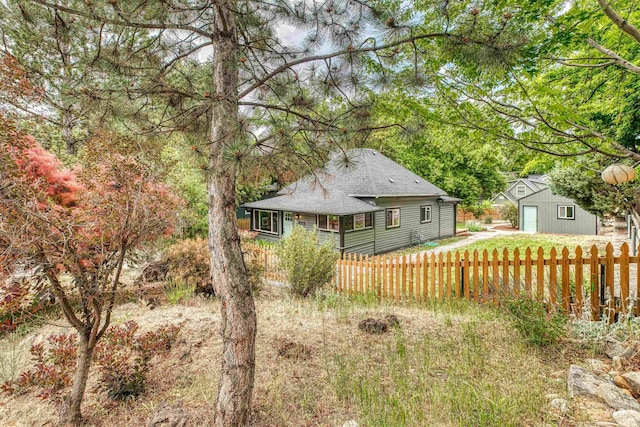 1605 N 5th St, Boise, ID 83702 - rear view of house featuring a shingled roof, an outbuilding, and a detached garage