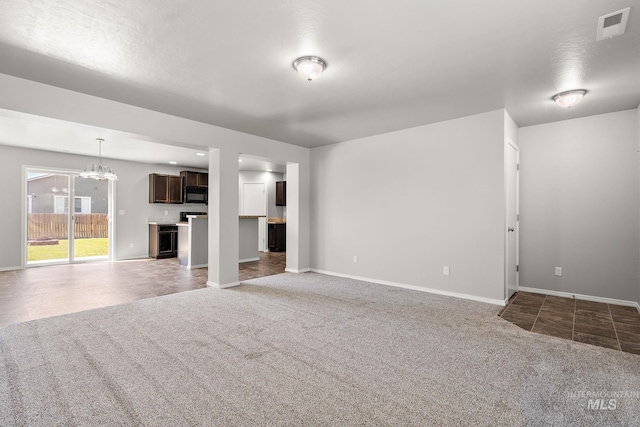 10619 Tysen Springs St, Nampa, ID 83687 - unfurnished living room featuring carpet, a chandelier, and baseboards