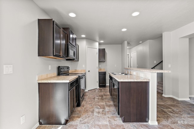 10619 Tysen Springs St, Nampa, ID 83687 - kitchen featuring black appliances, a kitchen island with sink, light countertops, recessed lighting, and dark brown cabinets