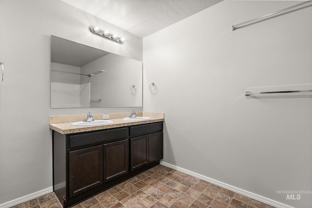 10619 Tysen Springs St, Nampa, ID 83687 - full bathroom featuring baseboards, double vanity, and stone finish floors