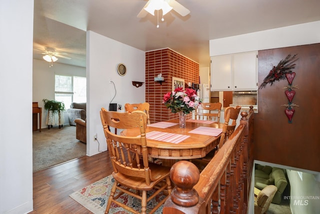 dining room featuring ceiling fan and wood finished floors